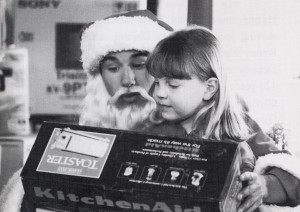 Jake (Jonathan Taylor Thomas, left) handing out gifts to children on his way home to New York. Photo credit: Alan Markfield, (C) The Walt Disney Company