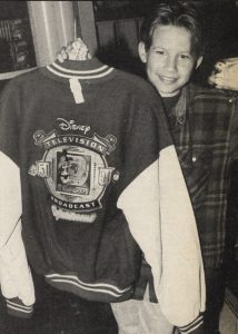 Jonathan Taylor Thomas holding the Disney Television Broadcast 40th anniversary jaket, while visiting the Disney souvenier store in Cleveland, Ohio.