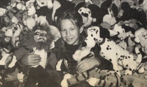 Jonathan Taylor Thomas in a pile of Disney plush toys while visiting the Disney souvenir store in Cleveland, Ohio.