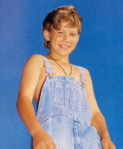 Jonathan Taylor Thomas wearing overalls.