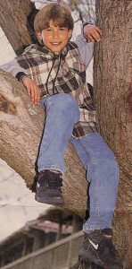 Jonathan Taylor Thomas climbing a tree